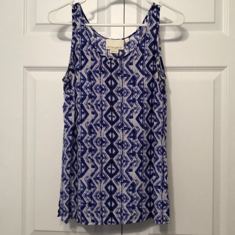 Blue and white sleeveless silk blouse.